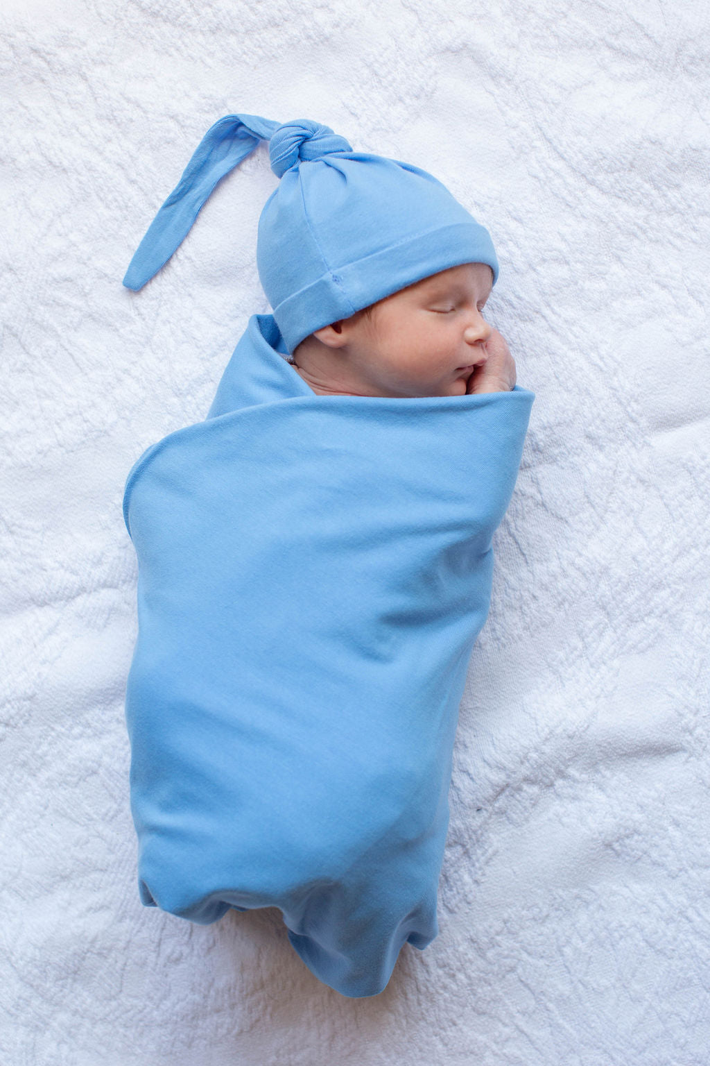 Baby boy receiving blanket and online hat